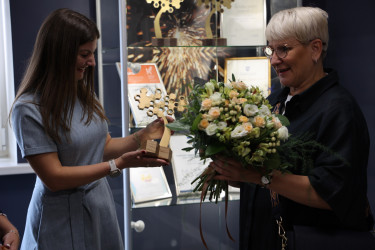 East Metal employee recieving award and flowers